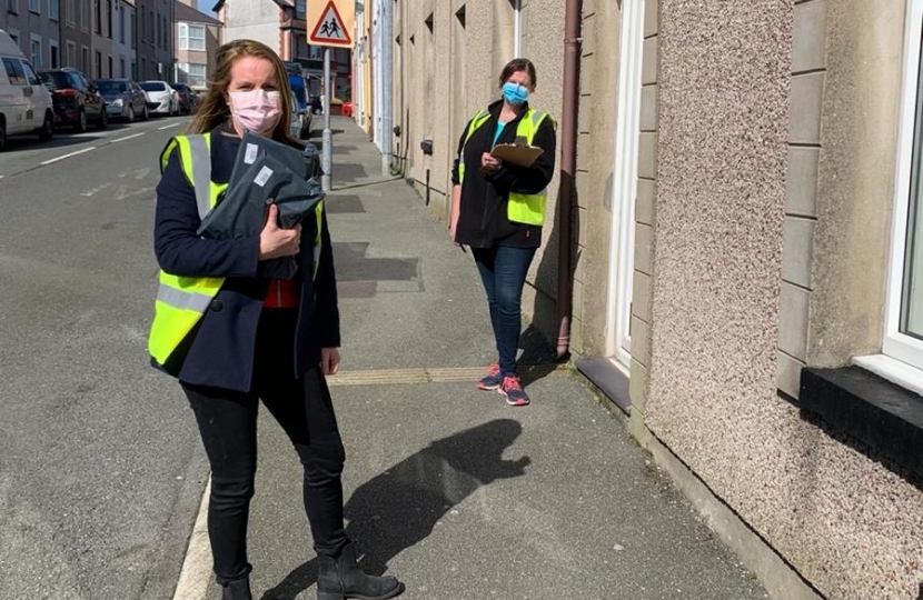 Virginia CroA picture of Virginia with another volunteer, Bethan, delivering test kits to Newry Street, Holyheadsbie MP with Bethan