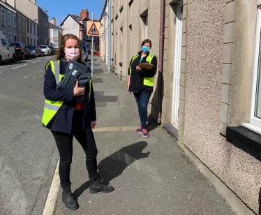 Virginia CroA picture of Virginia with another volunteer, Bethan, delivering test kits to Newry Street, Holyheadsbie MP with Bethan